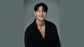 Kim Jong-guk smiling in a black shirt